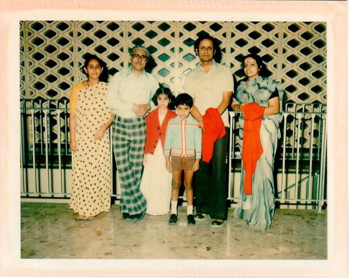 1970s photo of the family and friends in front of a patterned screen