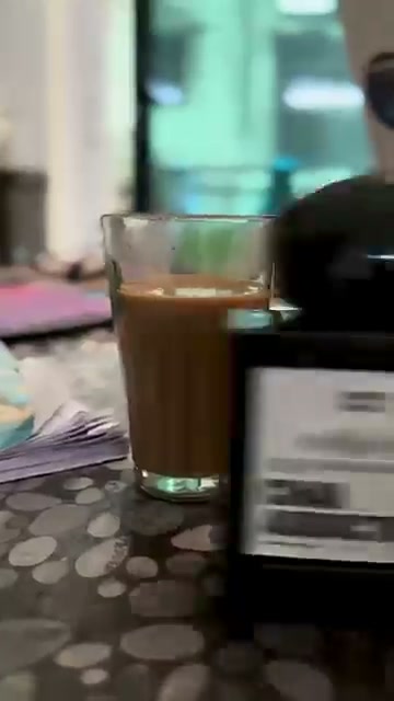 Cutting chai glass beside the bottle