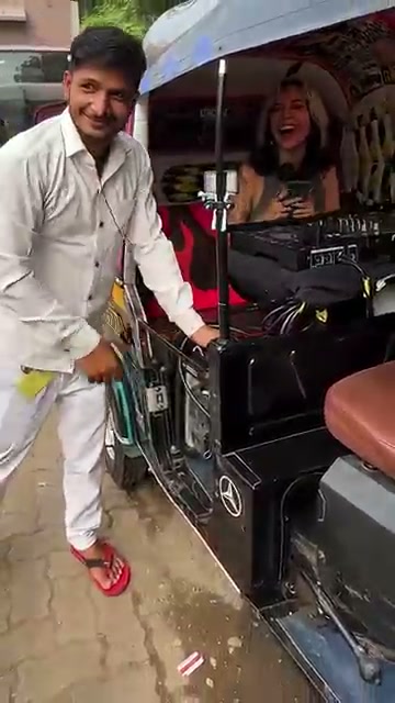 DJ-powered auto-rickshaw with driver and DJ