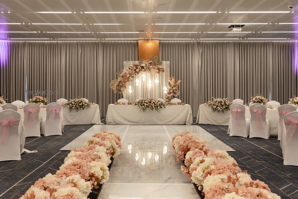 Hotel ballroom — floral stage backdrop, welcome flower aisle and dressed guest tables